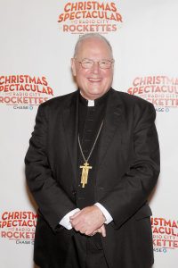 - New York, NY - 11/1/16 - His Eminence Timothy Cardinal Dolan Blesses the Animals from The Christmas Spectacular's "Living Nativity " Scene. Cardinal Dolan and the Radio City Rockettes on Tuesday, November 1, 2016 welcomed the camels, sheep and donkey back to Radio City Music Hall for their starring role in the “Living Nativity” scene in the 2016 production of the Christmas Spectacular Starring the Radio City Rockettes. The Christmas Spectacular Starring the Radio City Rockettes, presented by Chase, will run from November 11, 2016 – January 2, 2017 -Pictured: Cardinal Timothy Dolan -Photo by: Marion Curtis/Starpix -Location: Radio City Music Hall
